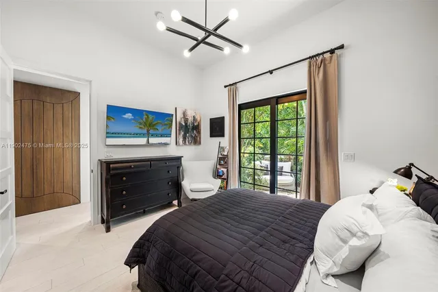 a living room with furniture ceiling fan and a large window