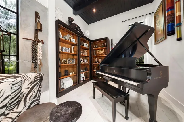 a living room with furniture a ceiling fan and a window