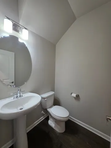 a kitchen with stainless steel appliances granite countertop a stove top oven a sink dishwasher a dining table and chairs with wooden floor