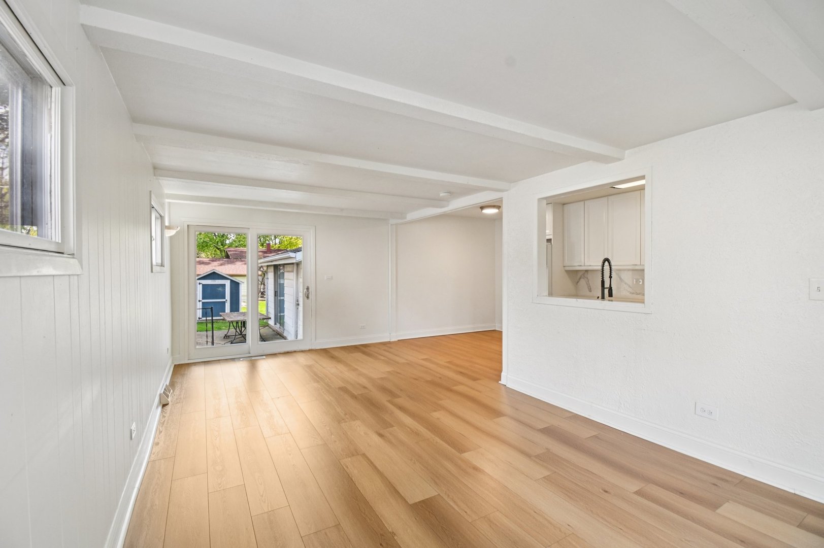 207 North Idlewild Avenue Mundelein, IL 60060 - Photo 11 of 46 a view of an empty room with wooden floor and a window