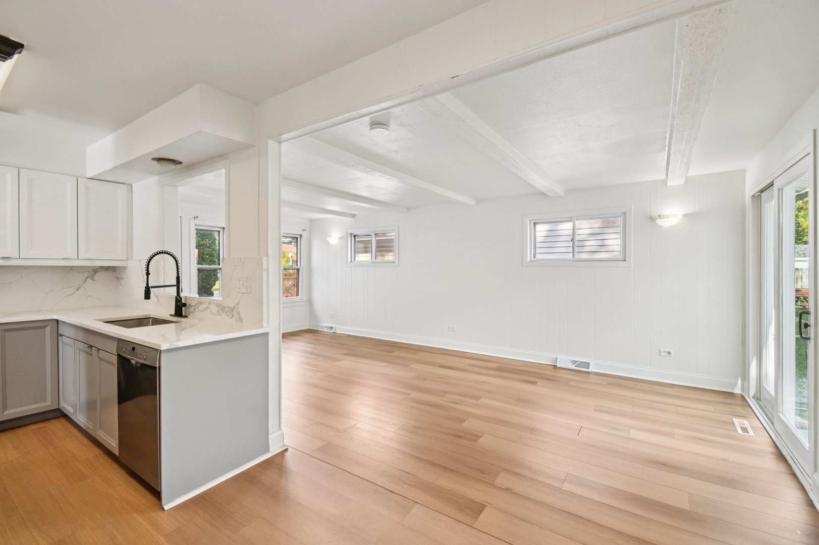 207 North Idlewild Avenue Mundelein, IL 60060 - Photo 15 of 46 a view of a kitchen with a sink wooden floor and a window