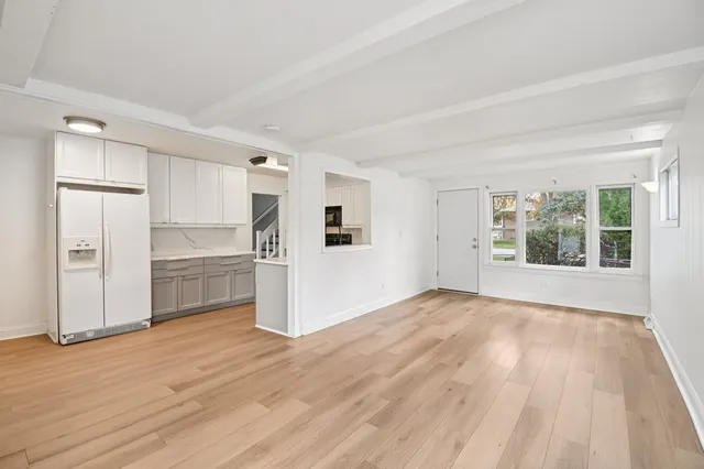 a view of a kitchen with wooden floor and a sink