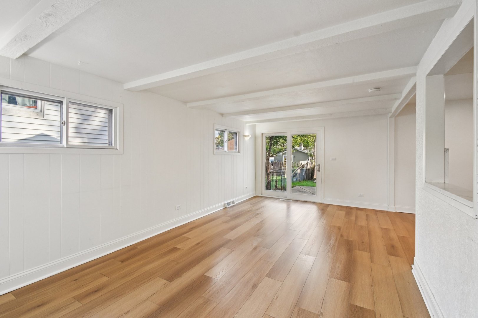 207 North Idlewild Avenue Mundelein, IL 60060 - Photo 10 of 46 a view of an empty room with wooden floor and windows