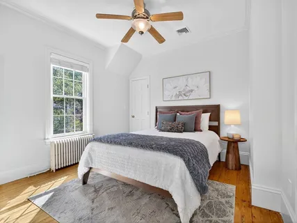 a bedroom with a bed and a window