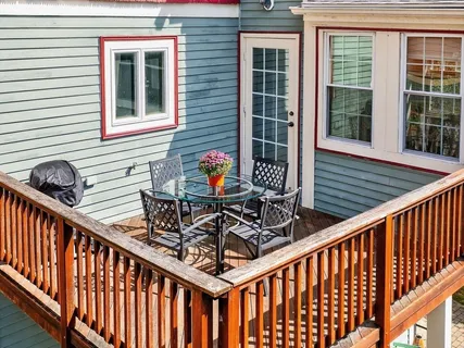 a view of a chairs and table in the balcony