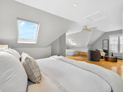 a bedroom with a large bed and a chandelier