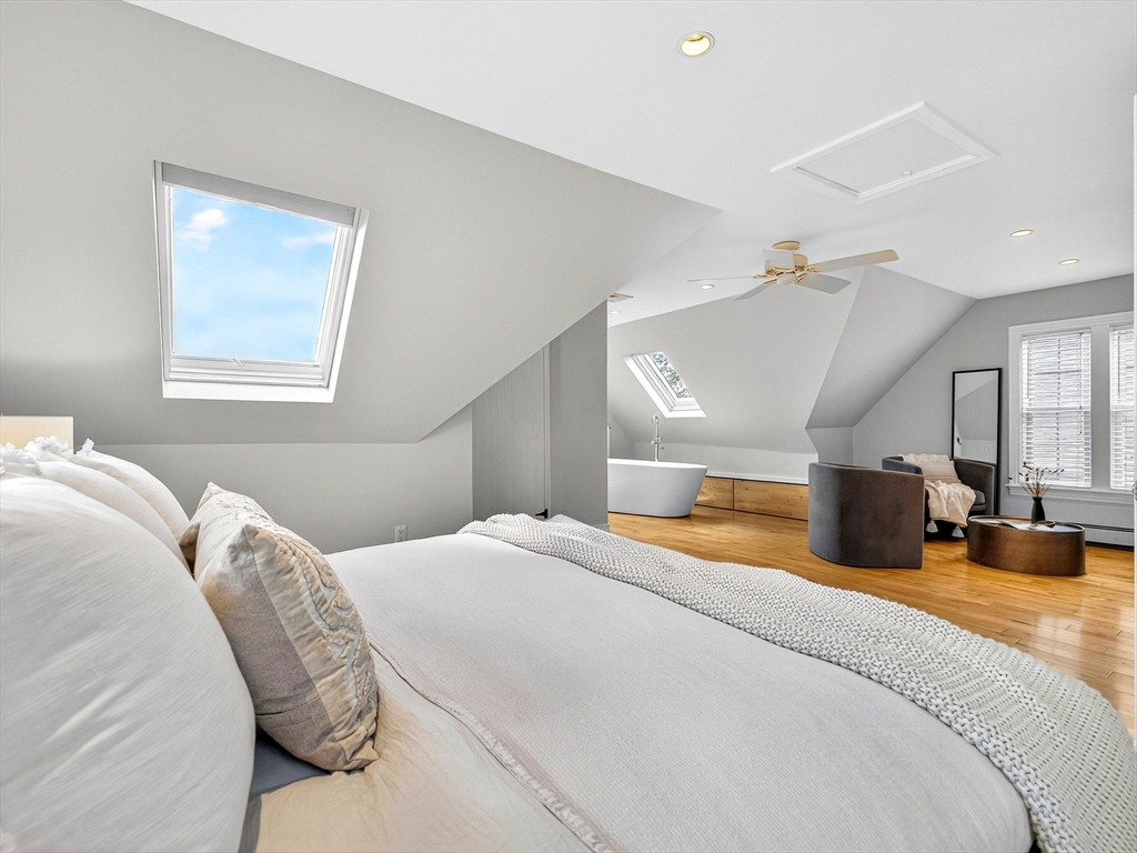 24 Evergreen Street, Unit 2 Boston, MA 02130 - Photo 18 of 31 a bedroom with a large bed and a chandelier