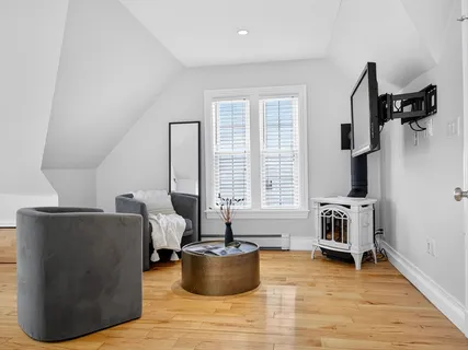 a living room with furniture and a potted plant