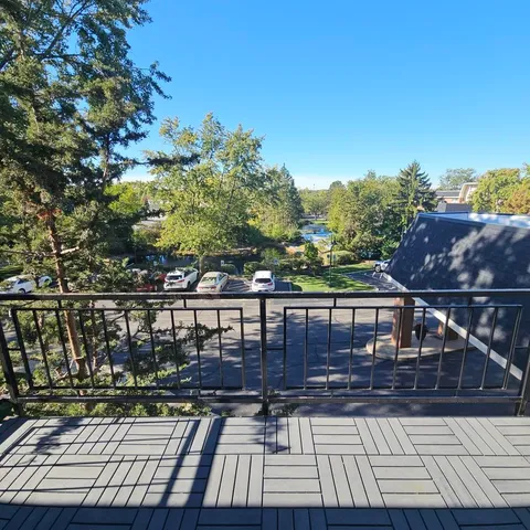 a spacious bedroom with a bed and a flat screen tv