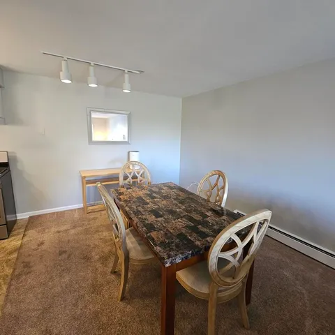 a living room with furniture a flat screen tv and a large window
