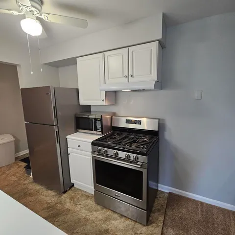 a kitchen with a sink stove and refrigerator