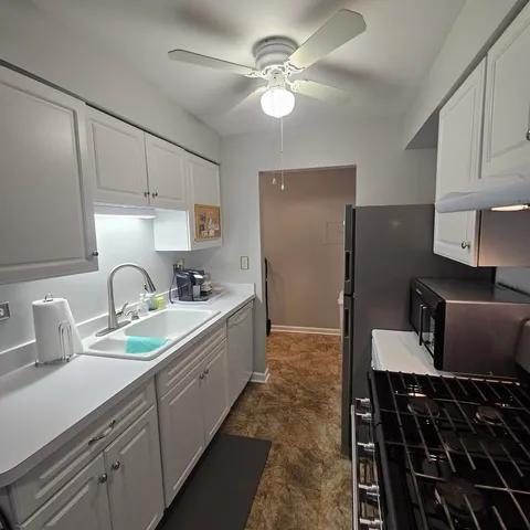 a kitchen with a sink appliances and cabinets
