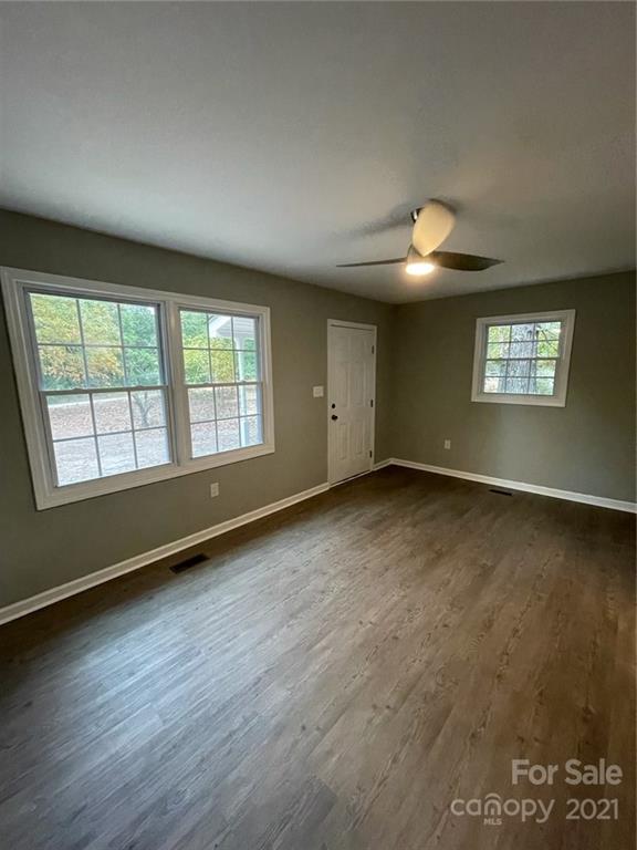 493 North Beersheba Road Clover, SC 29710 - Photo 5 of 7 an empty room with wooden floor and windows