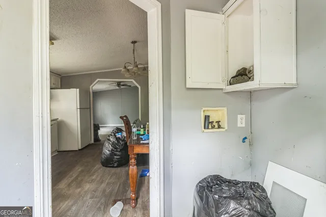 a view of hallway with livingroom and furniture