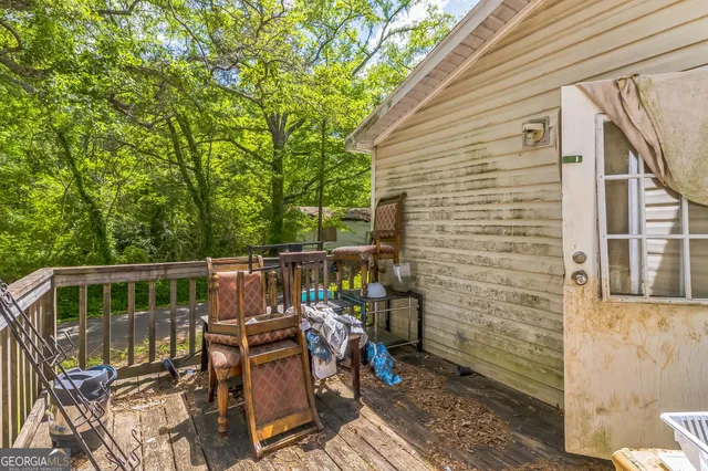 a view of balcony with wooden floor and outdoor seating