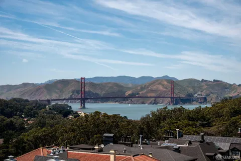 a front view of a house with potted plants