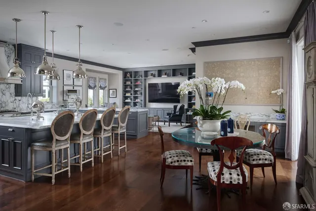 a kitchen with a dining table chairs a sink and a stove