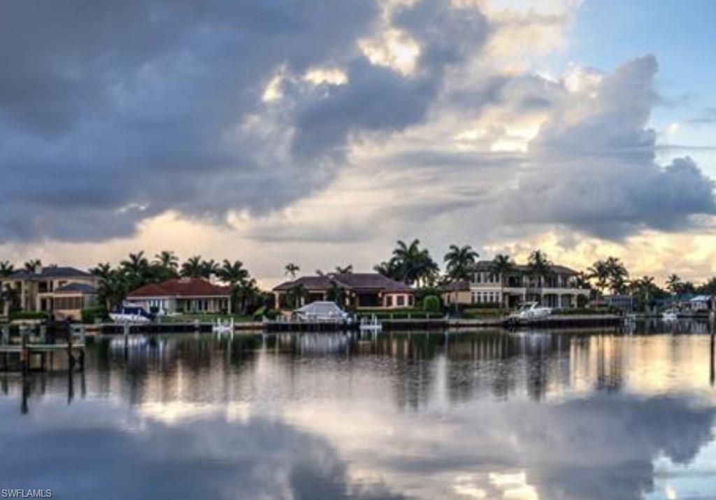 3215 Regatta Road Naples, FL 34103 - Photo 7 of 9 a view of a lake with boats and trees in the background