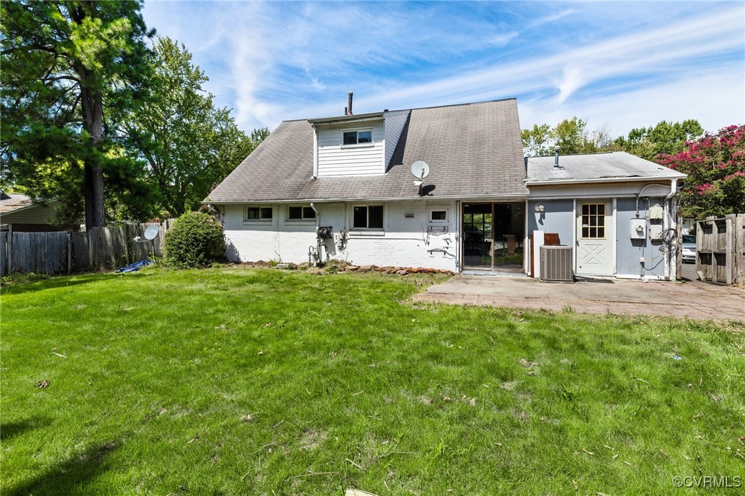 9219 Fisk Road Henrico, VA 23229 - Photo 17 of 18 Rear view of house with a lawn, central air condit