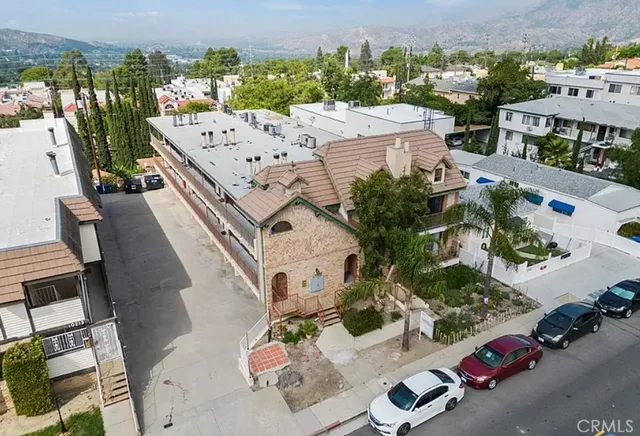 an aerial view of a house with yard