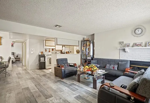 a living room with furniture cabinets and a window