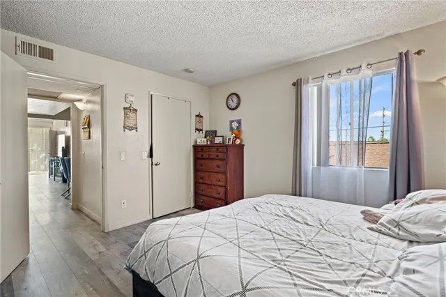 a bedroom with a large bed and a closet