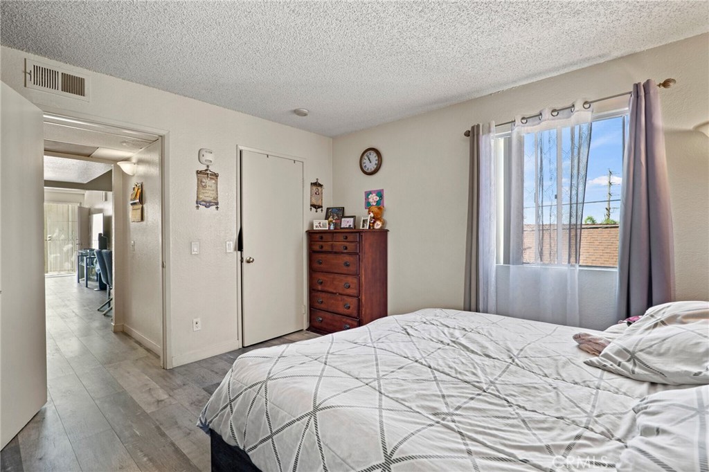 10219 Commerce Tujunga, CA 91042 - Photo 8 of 12 a bedroom with a large bed and a closet