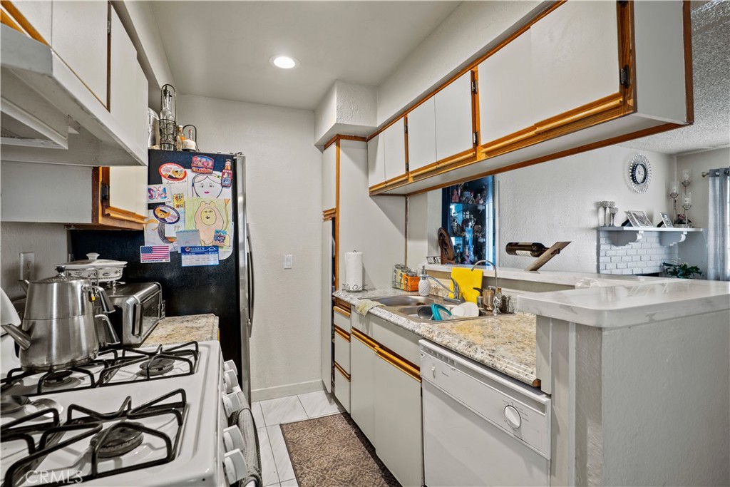 10219 Commerce Tujunga, CA 91042 - Photo 9 of 12 a kitchen with stainless steel appliances granite countertop a sink and cabinets
