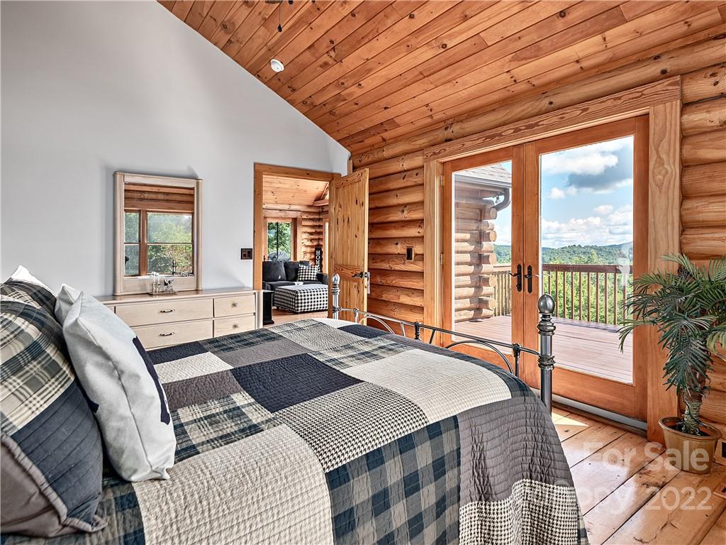 866 Pine Tree Road Spruce Pine, NC 28777 - Photo 11 of 38 a bedroom with a bed and glass windows