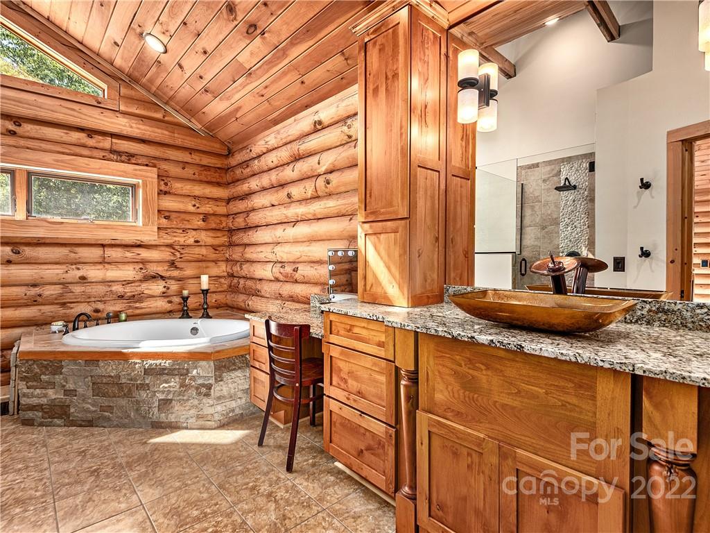 866 Pine Tree Road Spruce Pine, NC 28777 - Photo 12 of 38 a bathroom with a granite countertop sink and a mirror