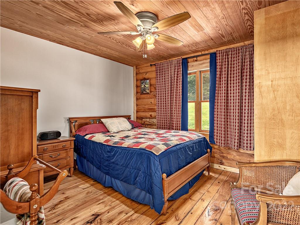 866 Pine Tree Road Spruce Pine, NC 28777 - Photo 14 of 38 a bed sitting in a bedroom next to a window