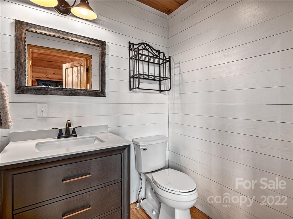 866 Pine Tree Road Spruce Pine, NC 28777 - Photo 15 of 38 a bathroom with a toilet a sink and mirror