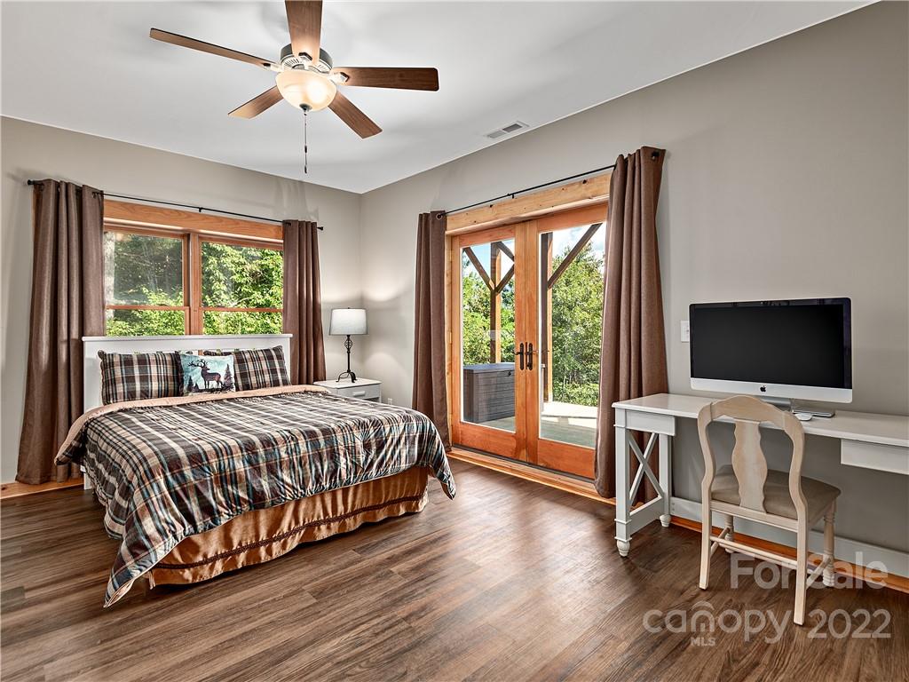 866 Pine Tree Road Spruce Pine, NC 28777 - Photo 17 of 38 a bedroom with a bed and a flat tv screen on the dresser