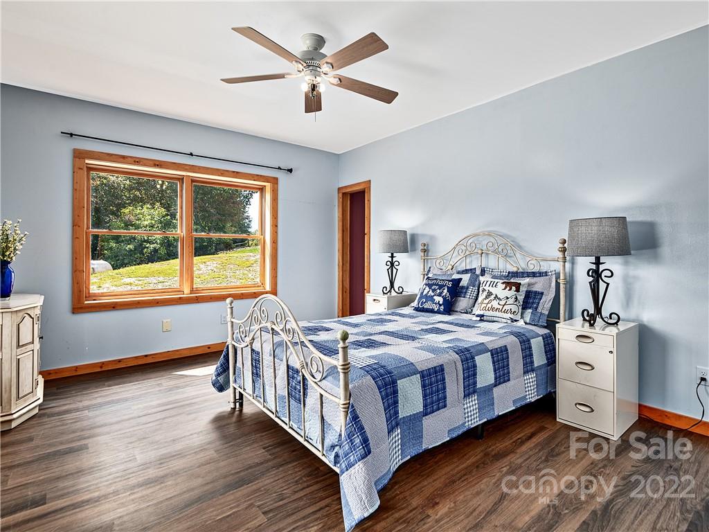 866 Pine Tree Road Spruce Pine, NC 28777 - Photo 22 of 38 a bedroom with a bed and a chandelier