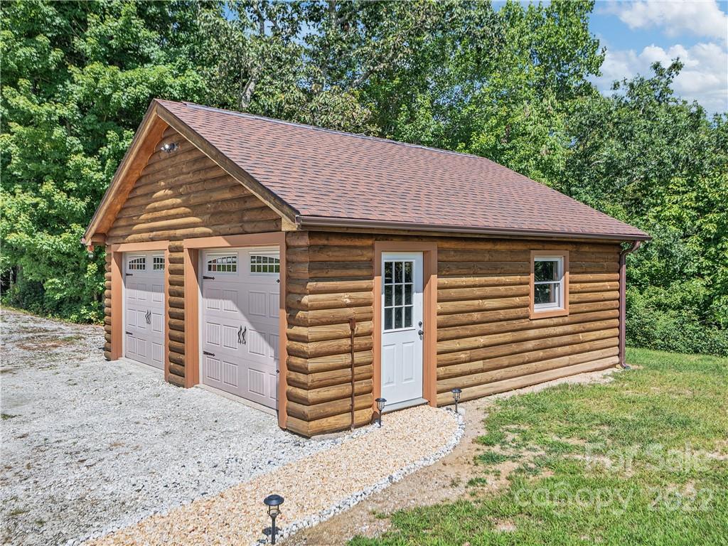 866 Pine Tree Road Spruce Pine, NC 28777 - Photo 28 of 38 a front view of a house with a yard