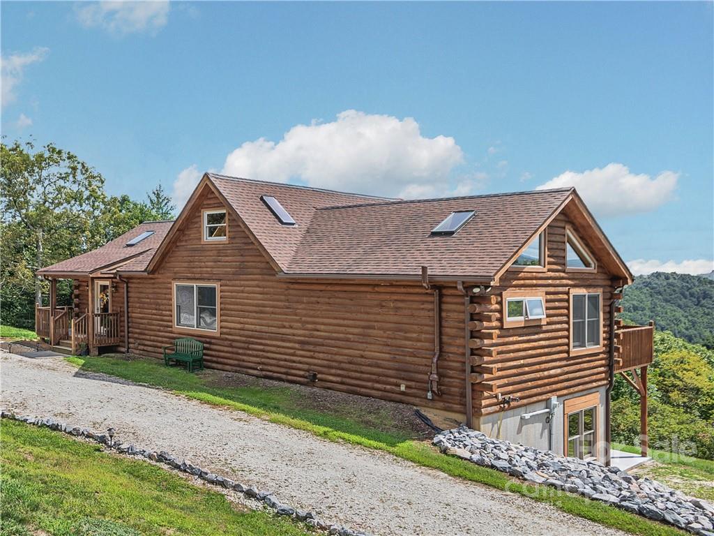 866 Pine Tree Road Spruce Pine, NC 28777 - Photo 32 of 38 a front view of a house with a yard and garage
