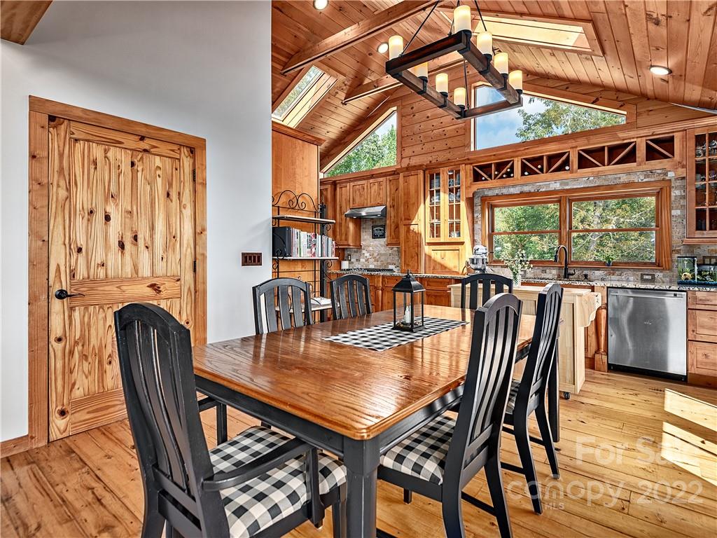 866 Pine Tree Road Spruce Pine, NC 28777 - Photo 4 of 38 a dining room with stainless steel appliances granite countertop a dining table and chairs with wooden floor