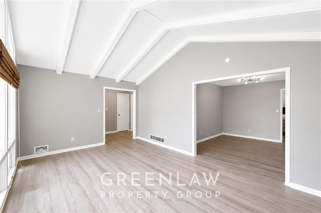 3605 Flat Shoals Road Atlanta, GA 30349 - Photo 6 of 35 a view of an empty room with wooden floor and a window