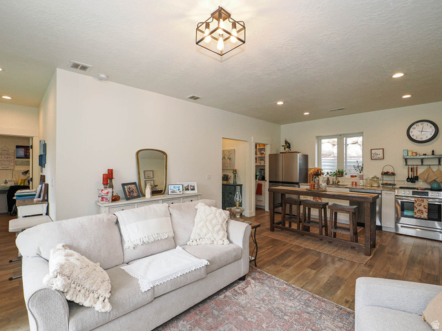 3167 South Mapleton Estates Drive Mapleton, UT 84664 - Photo 26 of 42 Living area with dark wood-style flooring, a textured ceiling, and recessed lighting