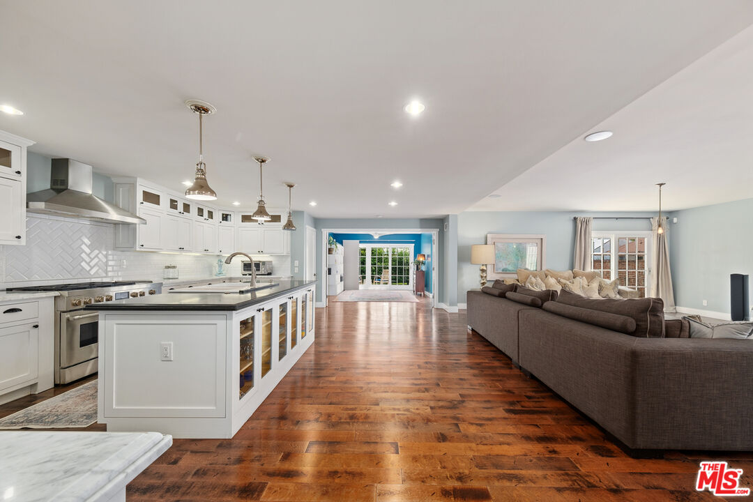 a open kitchen with stainless steel appliances granite countertop a stove and cabinets