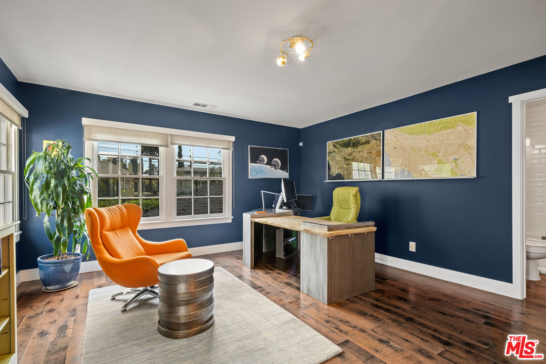 1632 Virginia Road Los Angeles, CA 90019 - Photo 15 of 26 a living room with furniture a flat screen tv and a floor to ceiling window