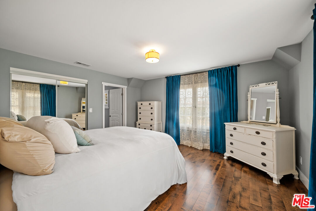 1632 Virginia Road Los Angeles, CA 90019 - Photo 16 of 26 a bedroom with a bed and wooden floor