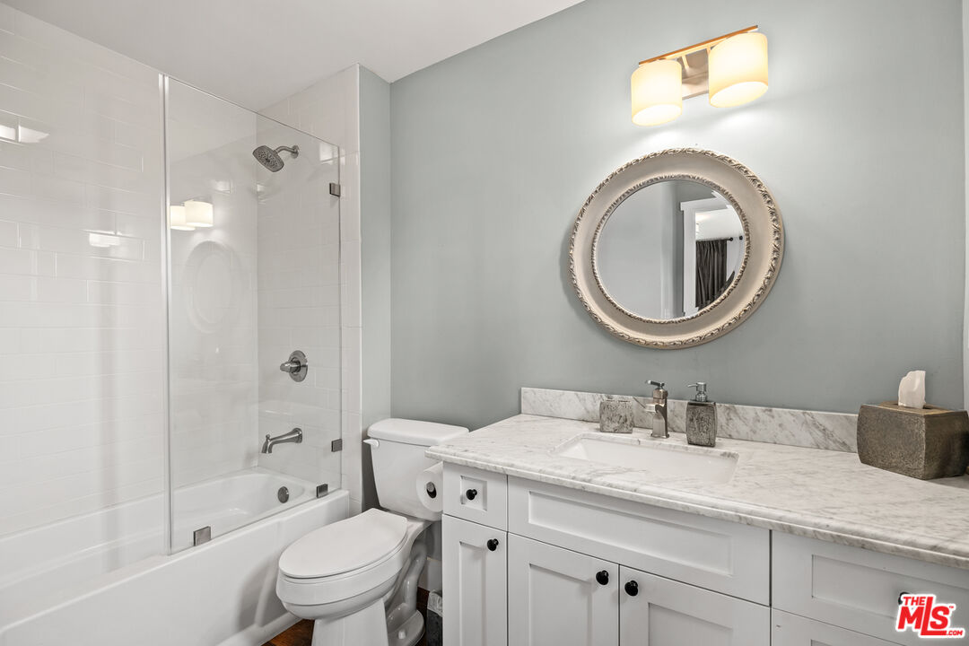 1632 Virginia Road Los Angeles, CA 90019 - Photo 17 of 26 a bathroom with a sink a toilet and a mirror