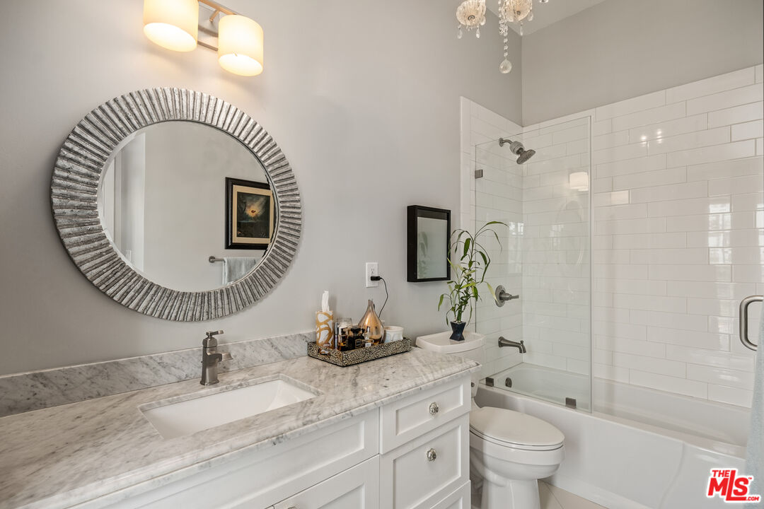 1632 Virginia Road Los Angeles, CA 90019 - Photo 19 of 26 a bathroom with a sink a toilet and a mirror