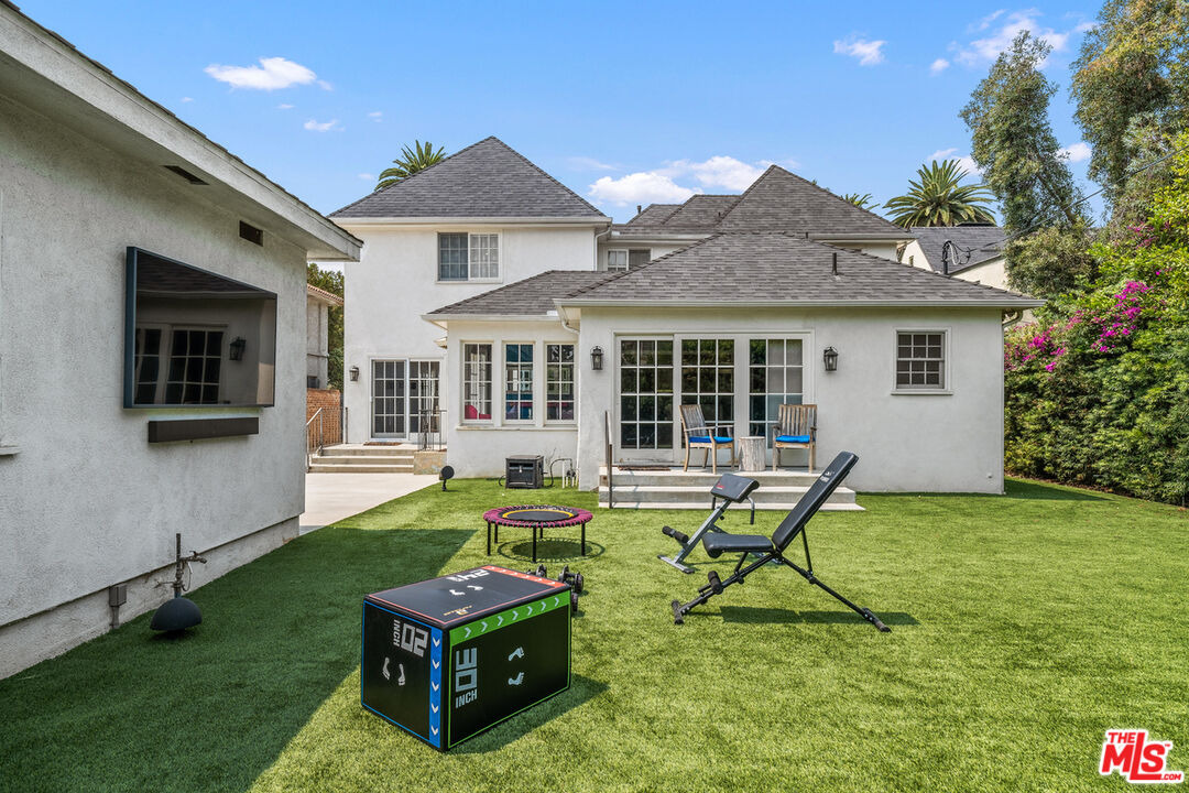 1632 Virginia Road Los Angeles, CA 90019 - Photo 22 of 26 a view of a house with backyard sitting area and garden