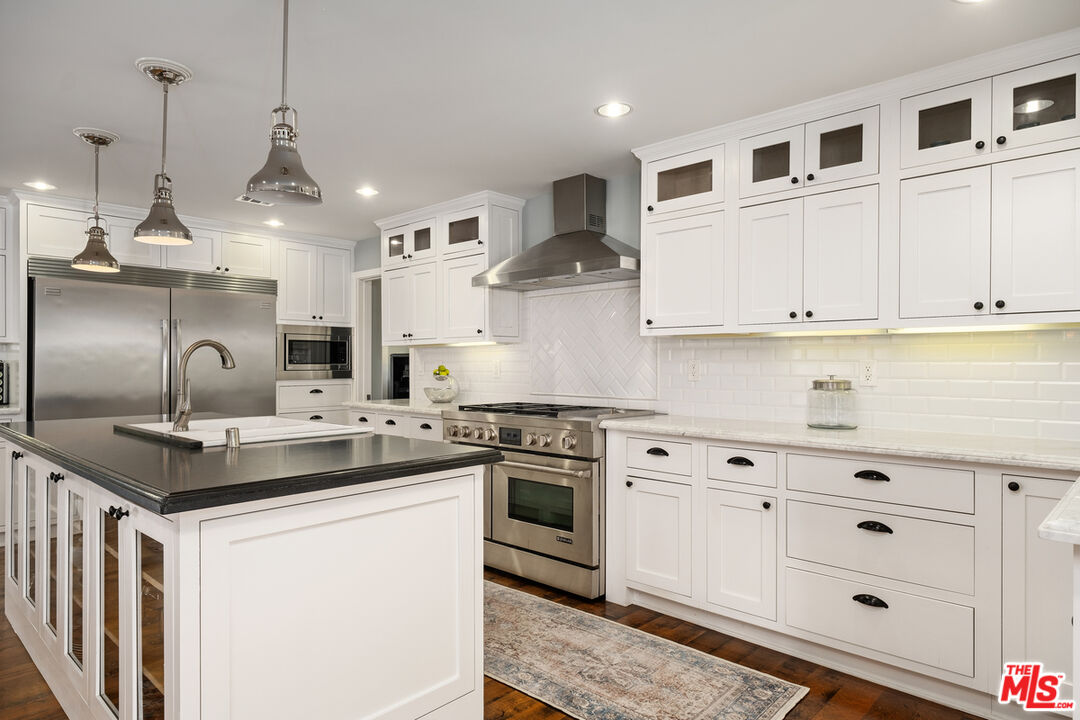 1632 Virginia Road Los Angeles, CA 90019 - Photo 8 of 26 a kitchen with stainless steel appliances granite countertop a sink a stove and a refrigerator
