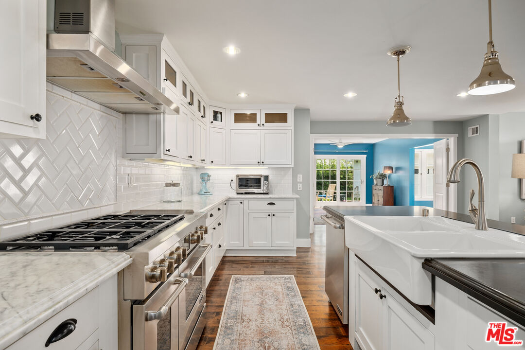 1632 Virginia Road Los Angeles, CA 90019 - Photo 9 of 26 a kitchen with granite countertop a sink stove and cabinets