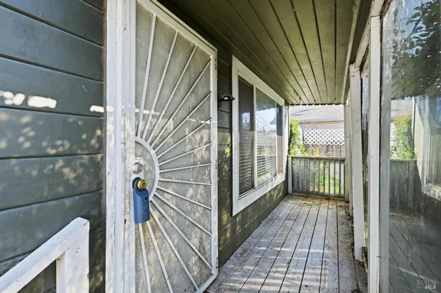 a view of a balcony with wooden floor