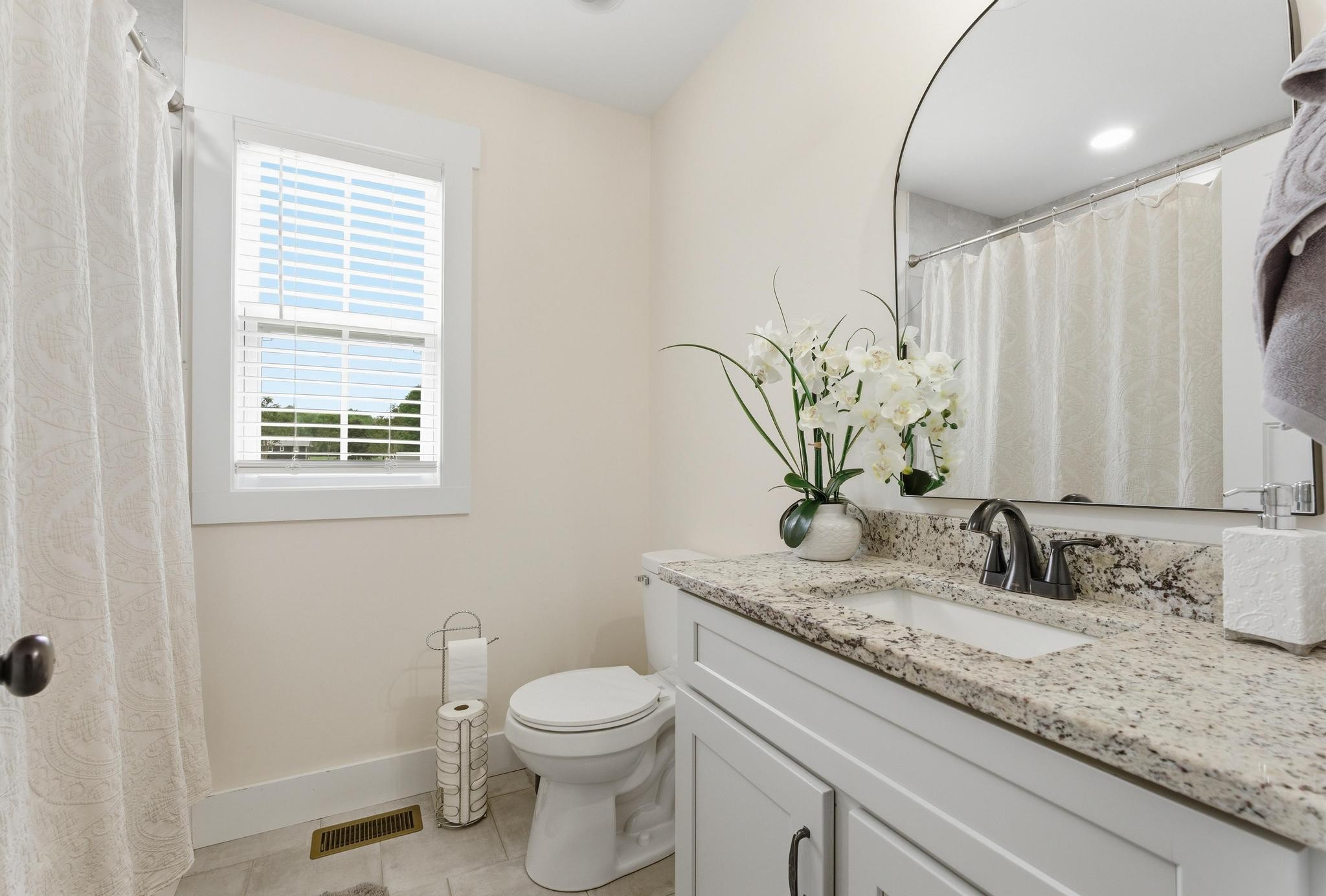 514 Cottage Way Cookeville, TN 38506 - Photo 17 of 21 a bathroom with a granite countertop sink a toilet and a window