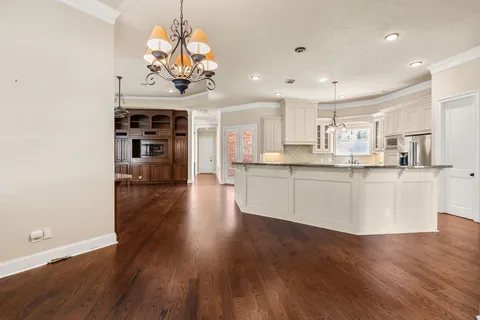 a view of a house with a yard and tree s